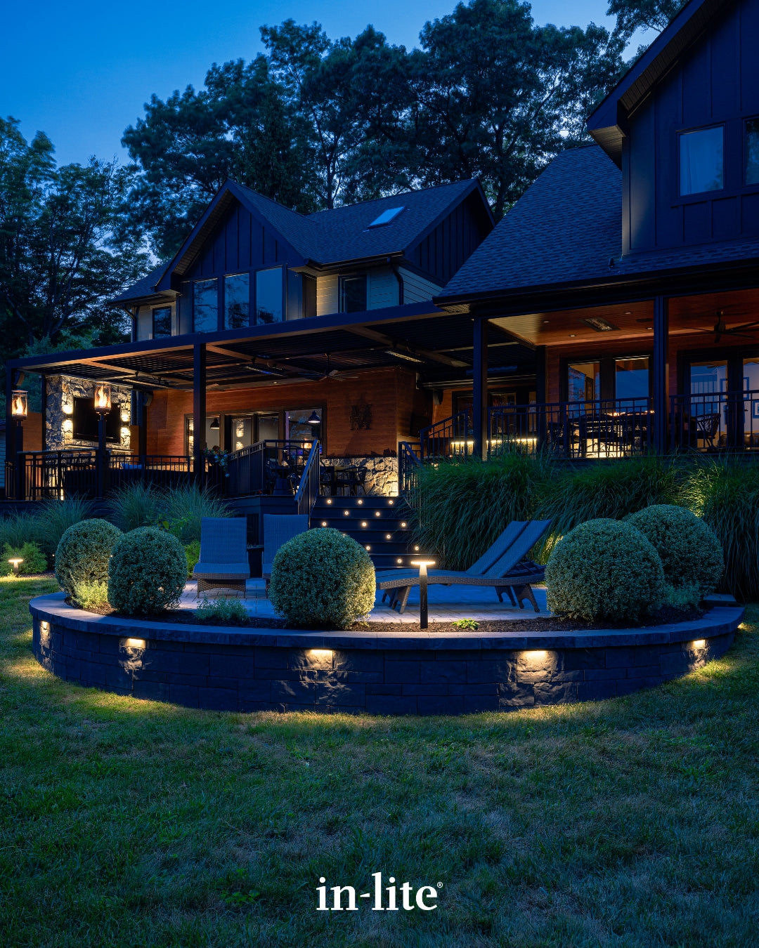 in-lite outdoor lighting illuminating a residential home, garden, patio, and landscape at dusk